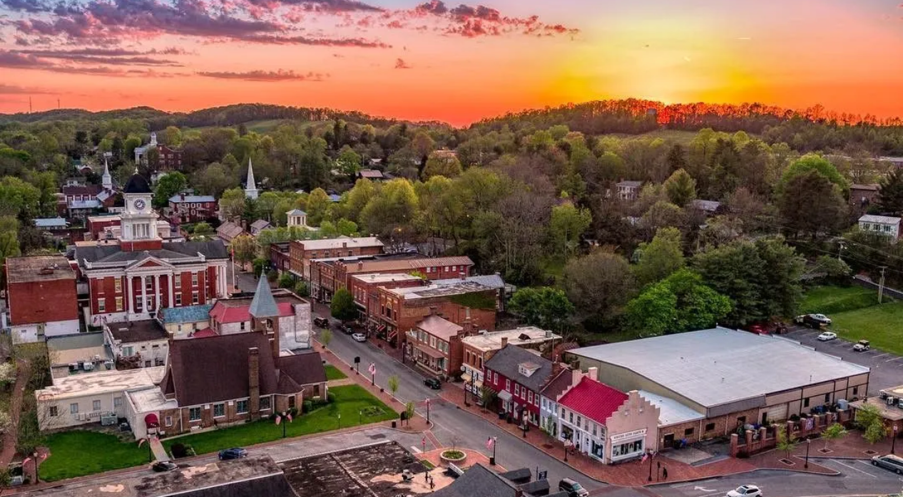 Picture of Downtown Jonesborough, TN with the sun setting over the mountains in the background