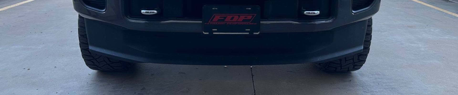 Rear view of a black truck with a license plate that has