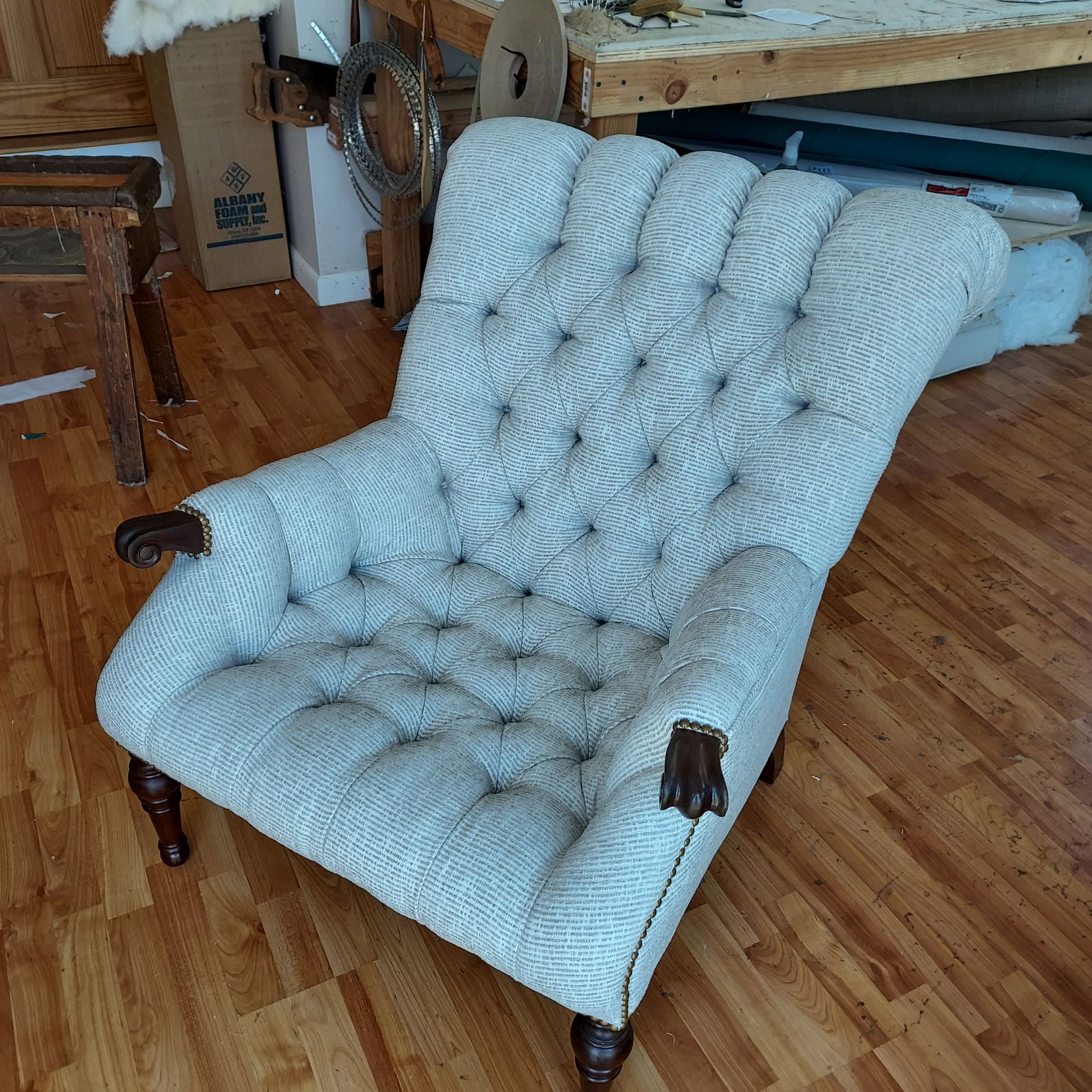 A white chair is sitting on a wooden floor