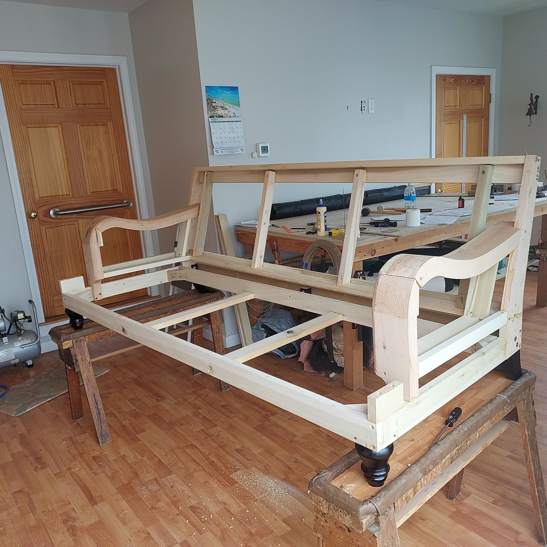 A pink couch is sitting on a pink rug in a room.