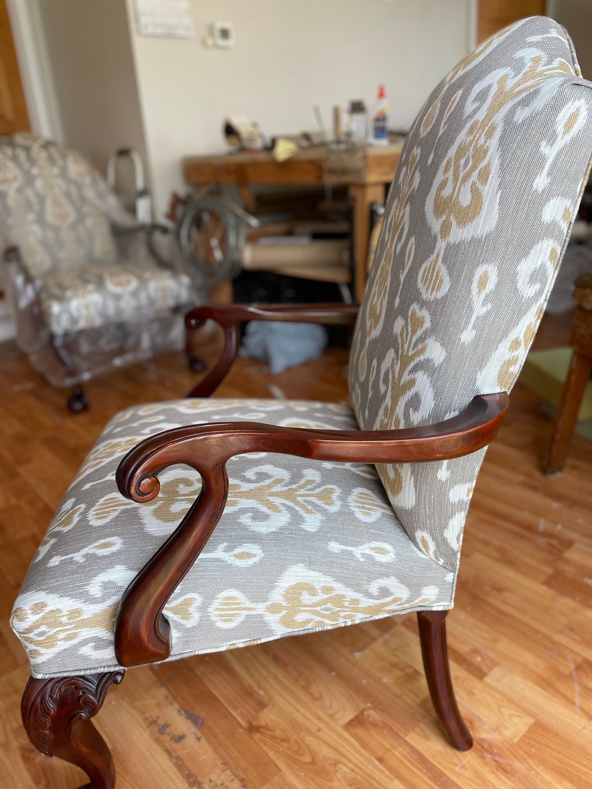 There are two chairs and a lamp in the room.