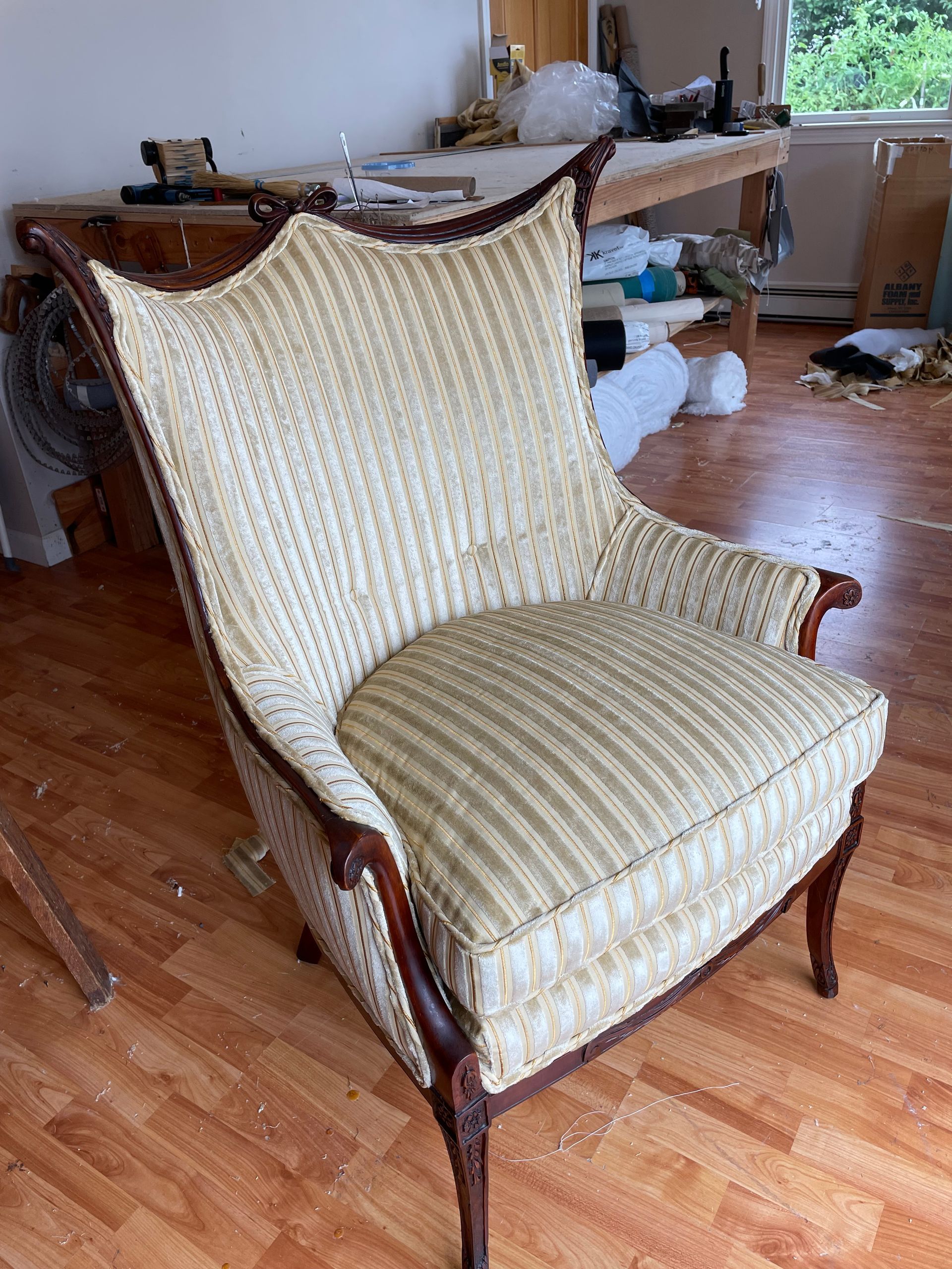 A chair is sitting on a wooden floor in a room.