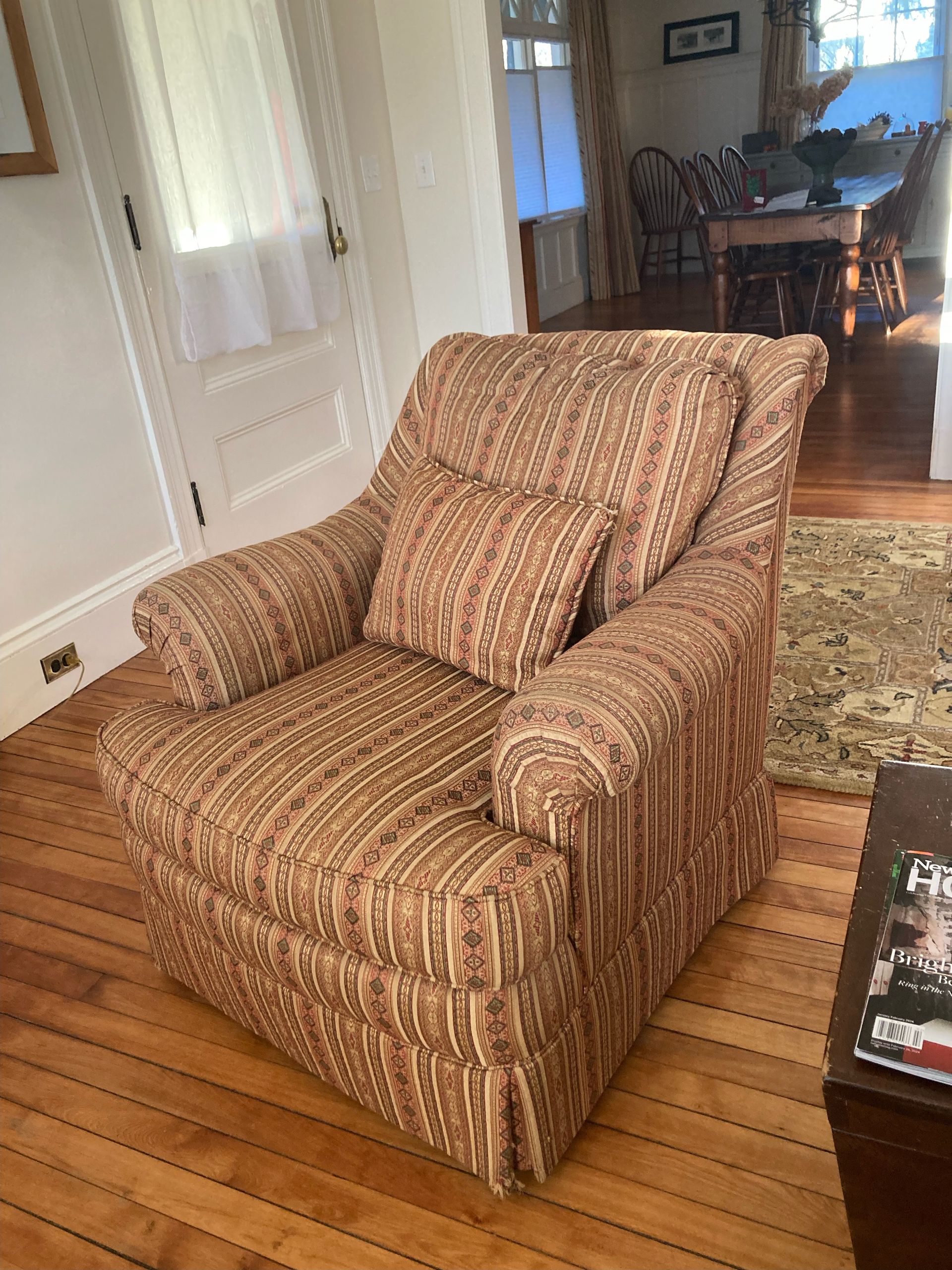 A chair is sitting on a wooden floor in a living room.