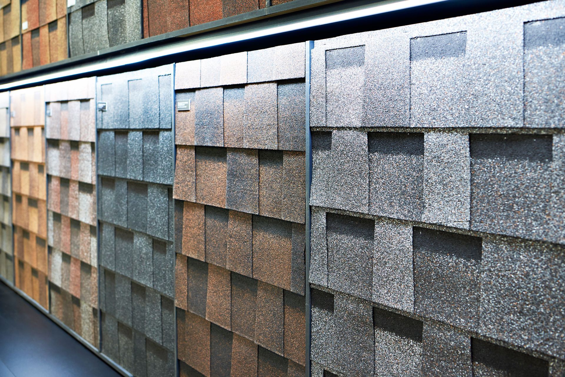 Shingle samples displayed in various colors, including brown, gray, and tan.