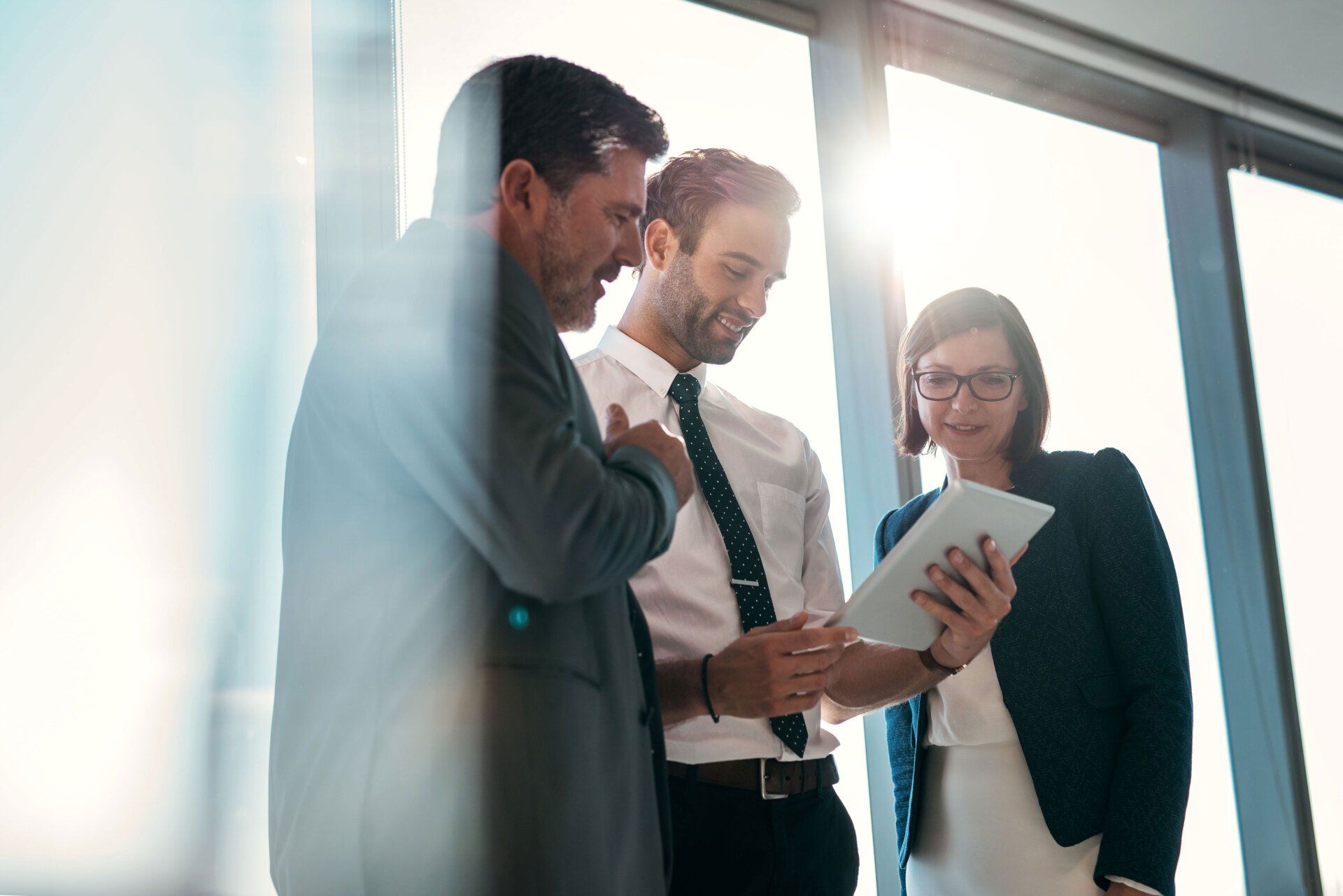 Group of businessmen using a digital tablet together