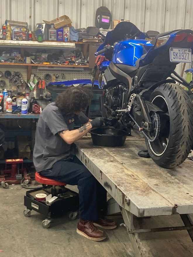 A bunch of motorcycle tires are lined up on a rack