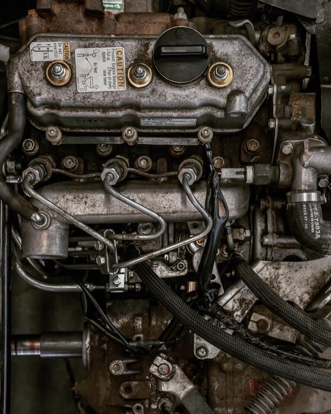 A close up of a diesel engine with a lot of wires coming out of it.