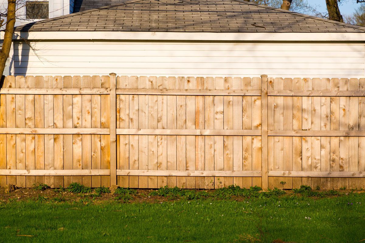 Hard Wood Fence Outside a House — Bondurant, IA — Titan Fence LLC