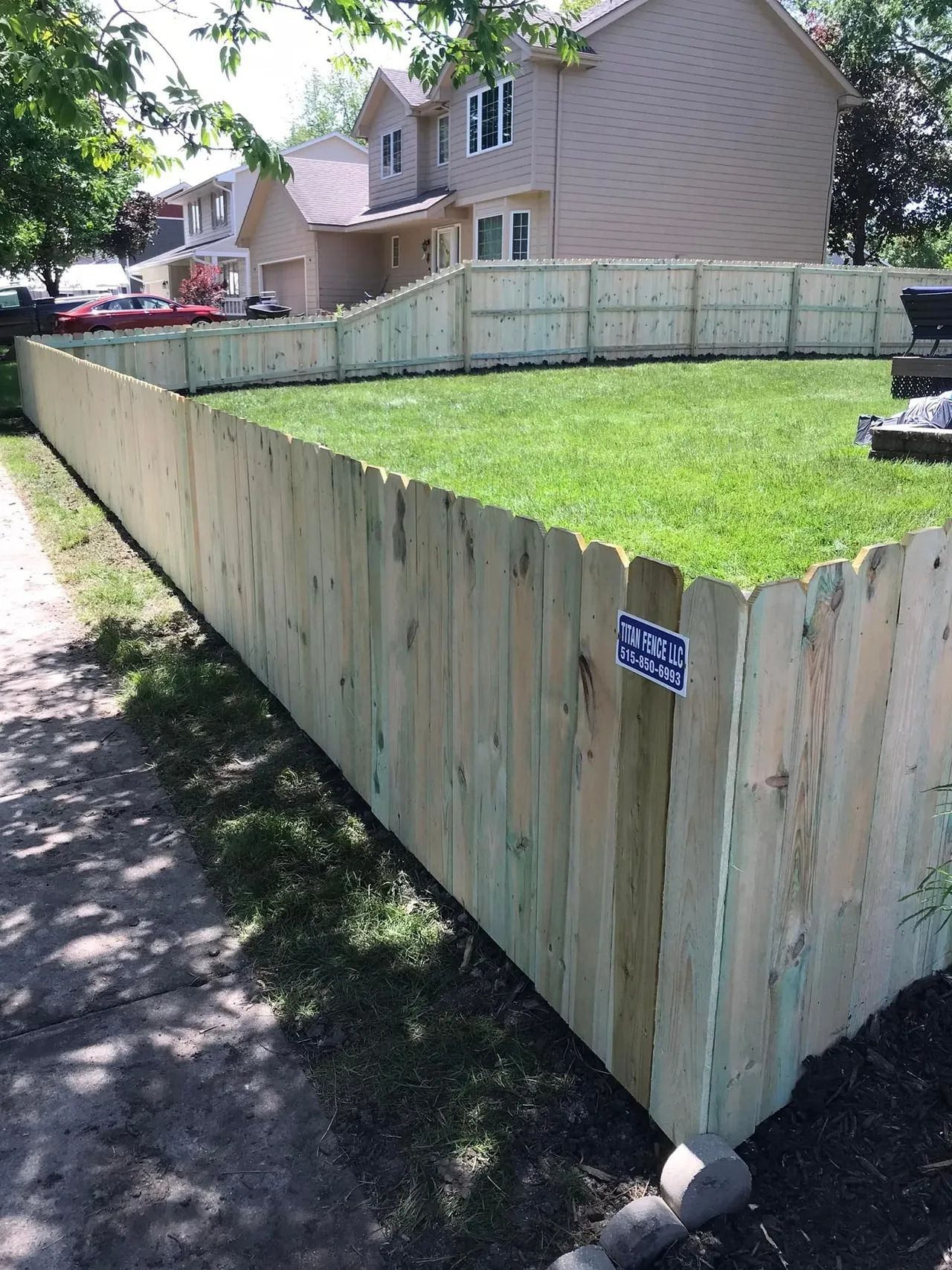 Wooden Fence Surrounds a Lush Green Yard — Bondurant, IA — Titan Fence LLC