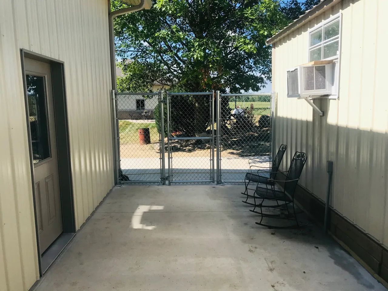 Patio with Rocking Chairs and a Fence — Bondurant, IA — Titan Fence LLC