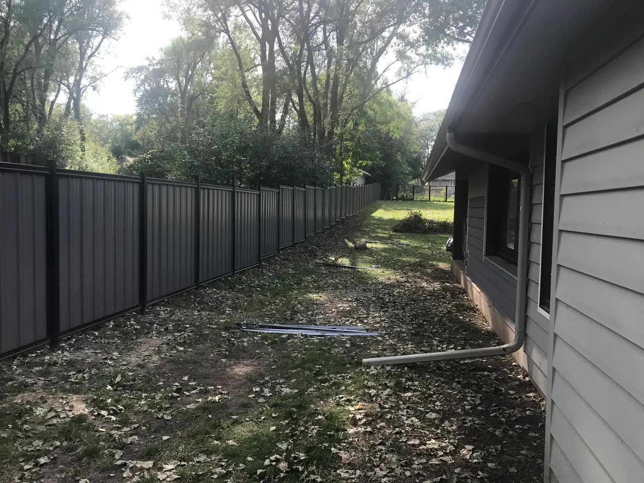 Backyard of a House with a Fence and Trees — Bondurant, IA — Titan Fence LLC