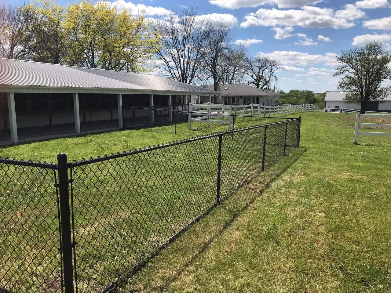 Chain Link Fence Surrounds a Grassy Field — Bondurant, IA — Titan Fence LLC