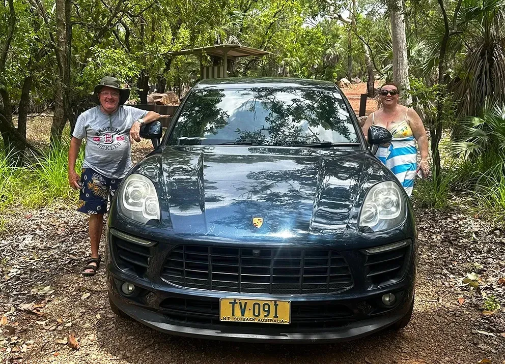 A Couple Pose With Litchfield Vip Tours Porsche — Litchfield VIP Tours In Darwin City, NT