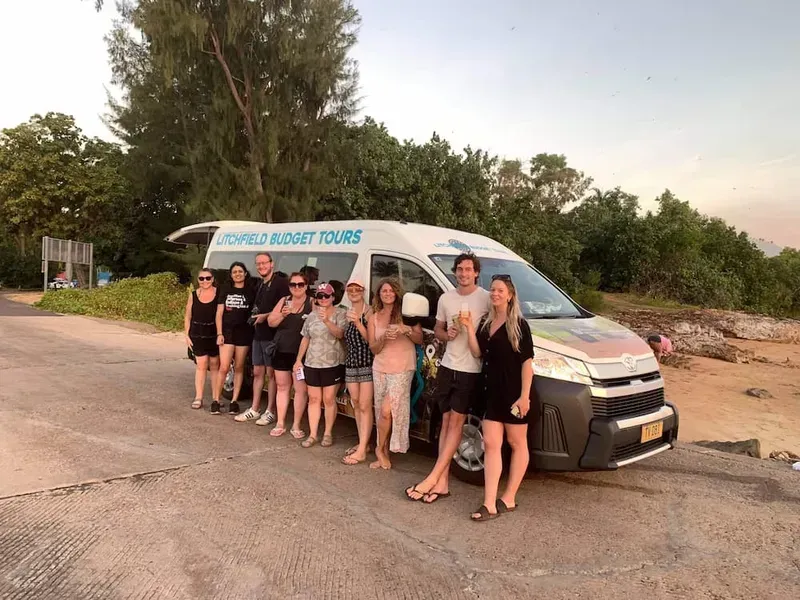 Group of People Posing by a Tour Van Labeled — Litchfield VIP Tours In Darwin City, NT