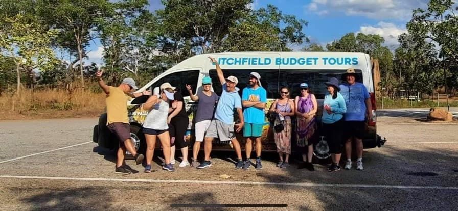 Group of People Posing by a Van That Says Litchfield Budget Tours — Litchfield VIP Tours In Darwin City, NT