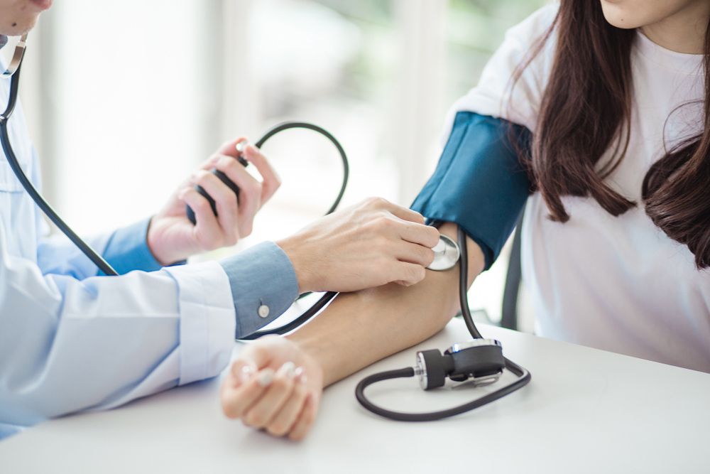 Doctor Checking Blood Pressure To A Woman — Blood Pressure Monitoring in Wulguru, QLD
