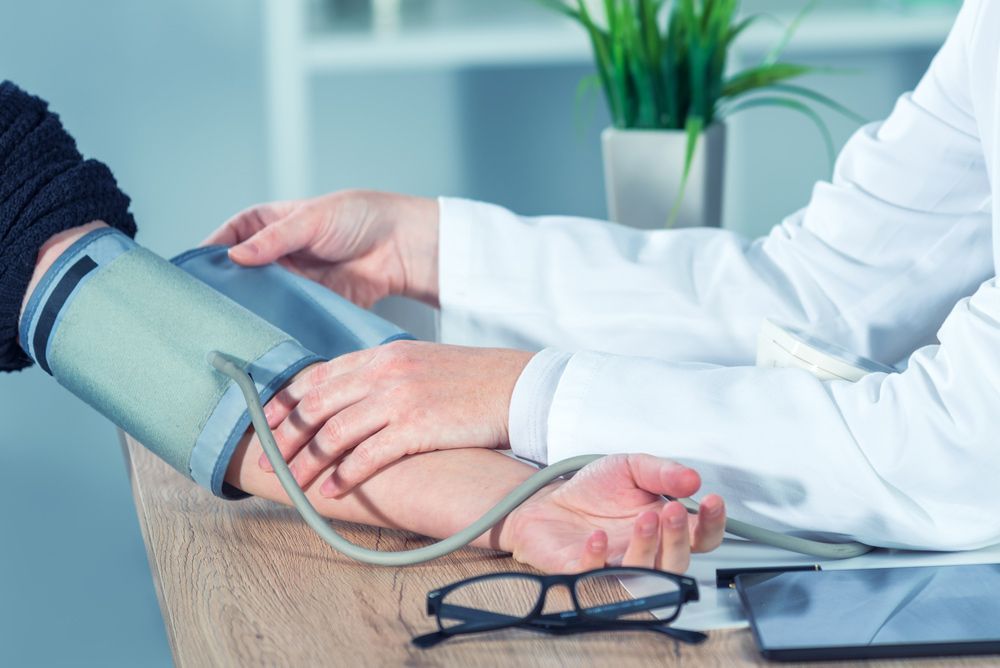 Doctor Cardiologist Measuring Blood Pressure Of A Woman — Blood Pressure Monitoring in Wulguru, QLD
