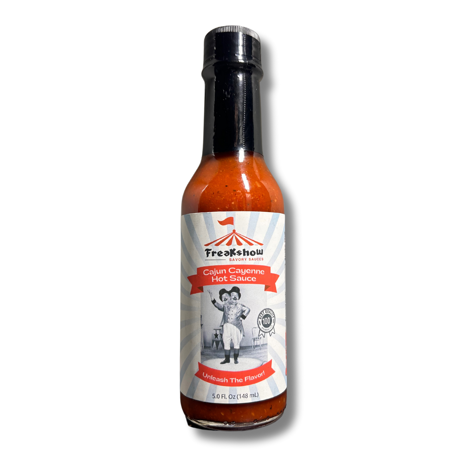 A bottle of cajun cayenne hot sauce is sitting on a red podium.