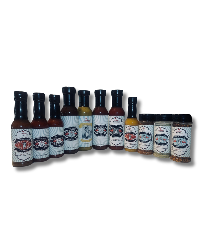 a row of hot sauces and spices are lined up in a row on a white background .