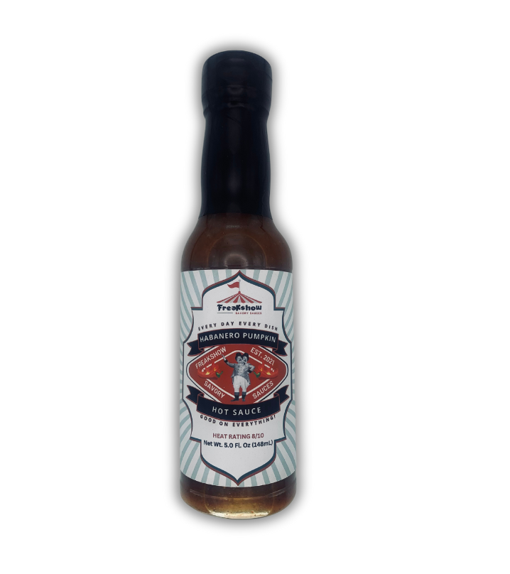 a bottle of freakshow savory sauces habanero pumpkin hot sauce with mascot bob clarence on the label .