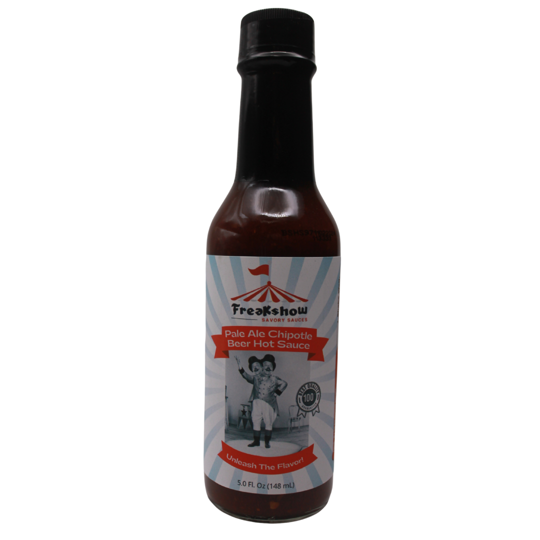 a bottle of freakshow savory sauces pale ale chipotle hot sauce with mascot bob clarence on the label .