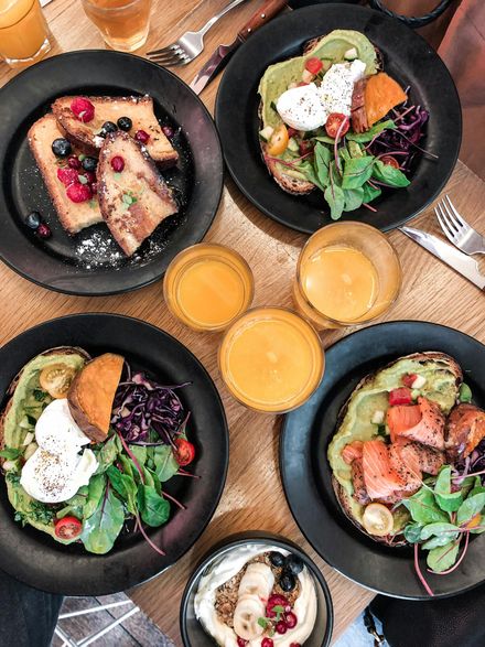 A table topped with plates of food and drinks.