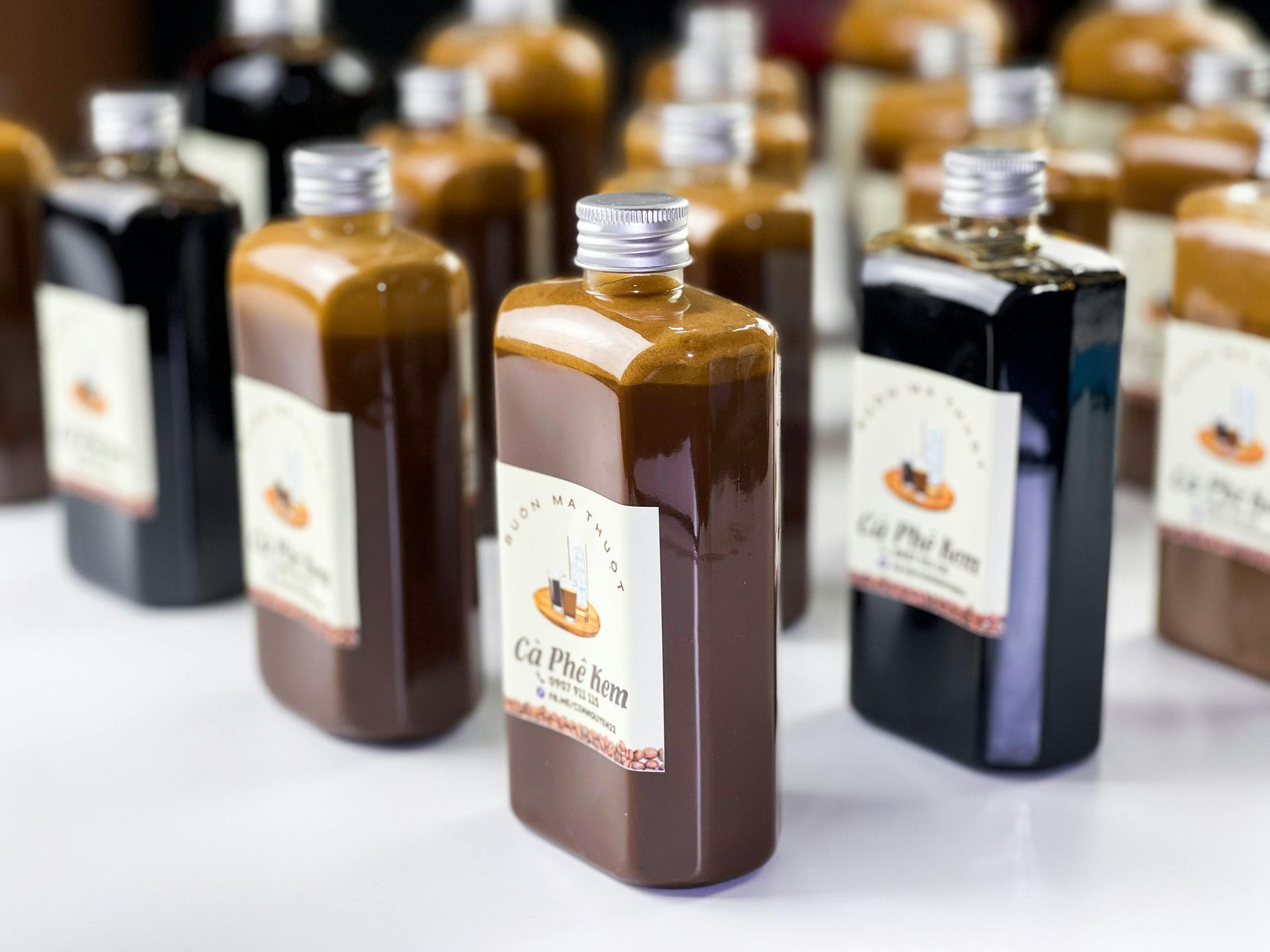 A group of bottles sitting on top of each other on a table.