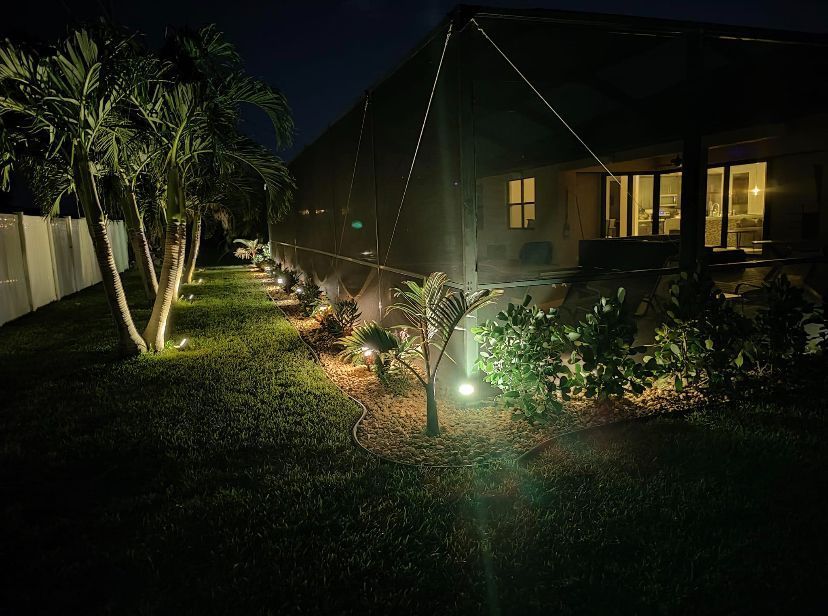 The Backyard of a House is Lit Up at Night - Lehigh Acres, FL - Mainor Landscaping Service LLC