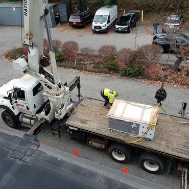 An aerial view of a truck with a crane attached to it.