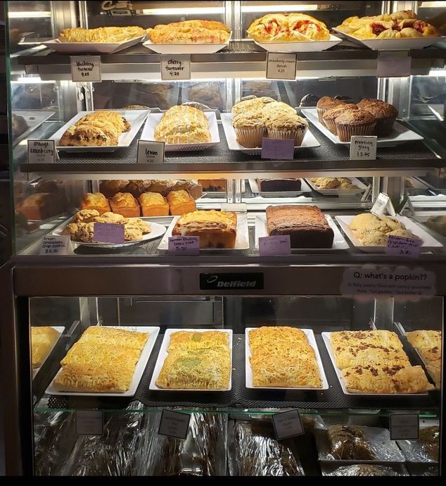 A display case filled with a variety of pastries and cakes