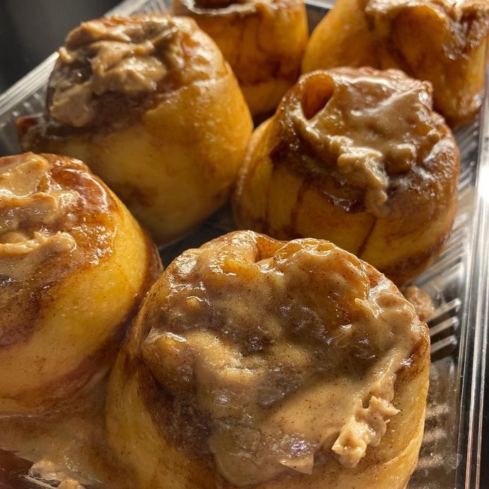 A close up of cinnamon rolls in a plastic container