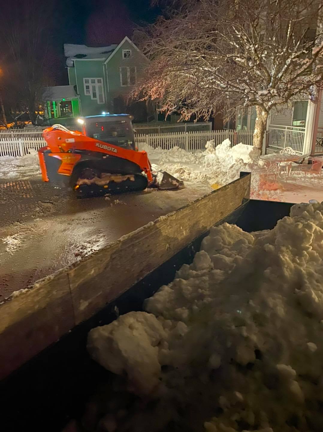 Skid loader and dump truck hauling snow during Central Iowa storm – CD’s Lawn Care