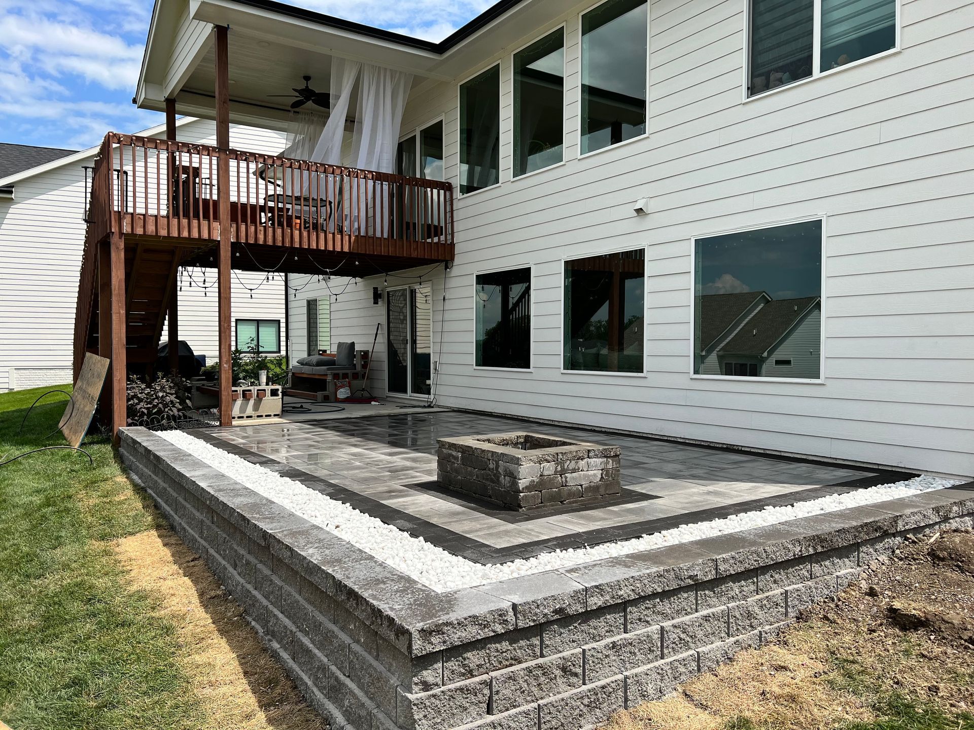 Custom patio with built-in fire pit designed and installed by CD’s Lawn Care in Central Iowa