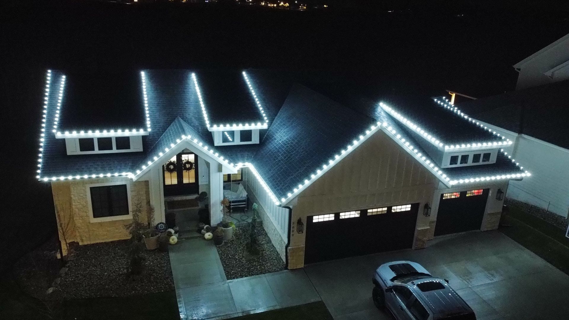 Bright white C9 holiday lights installed on a Central Iowa home by CD’s Lawn Care