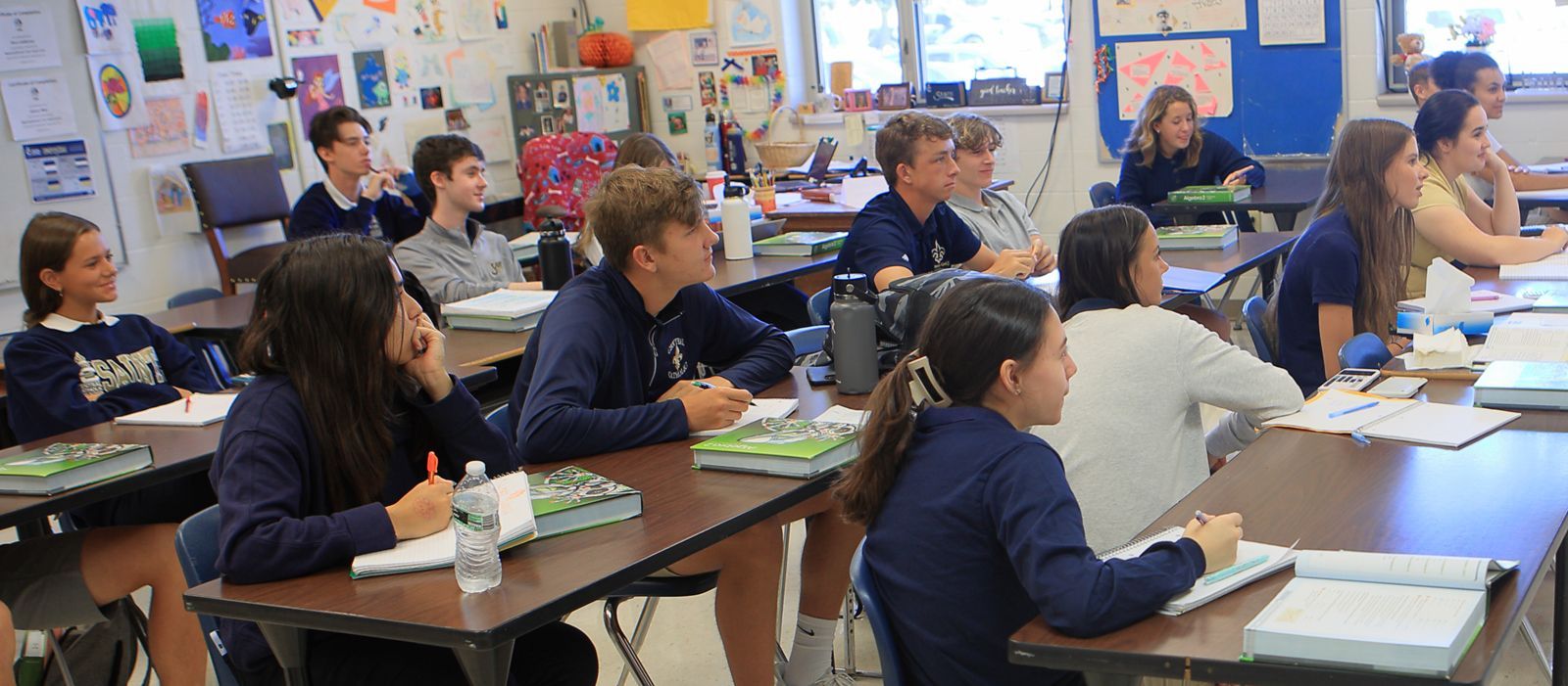 A group of children are sitting at desks in a classroom.