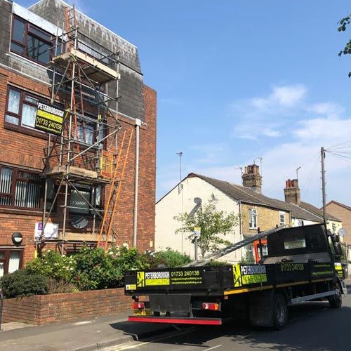 Truck outside a building with scaffold