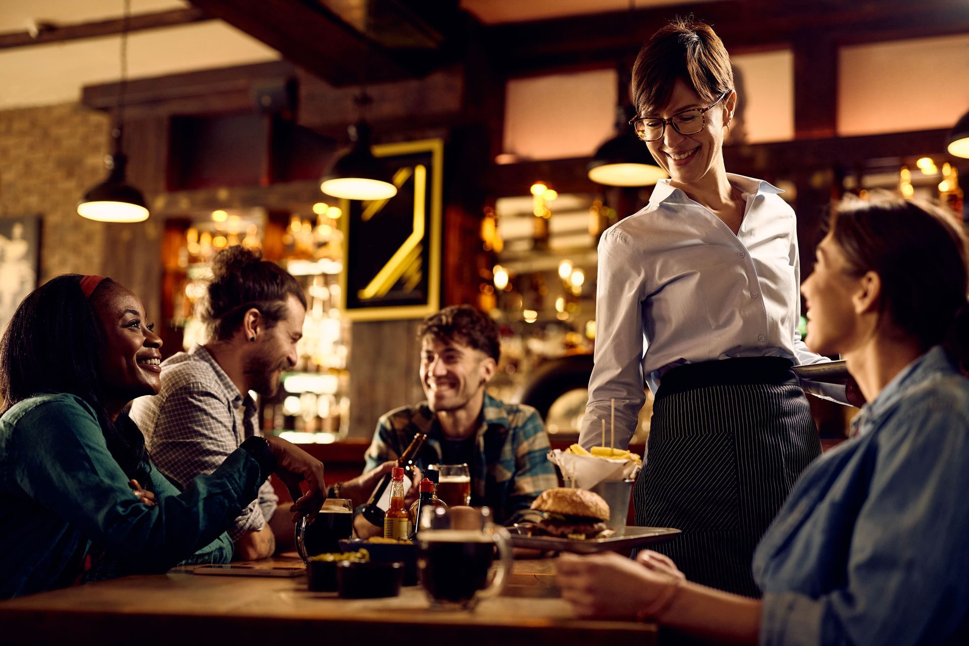 Bright living room with white sectional sofa, dresser, floor lamp, and window coverings.