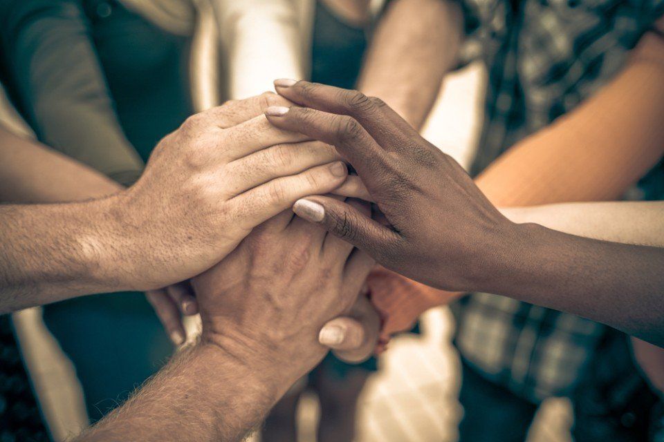 group of worker stacking hands