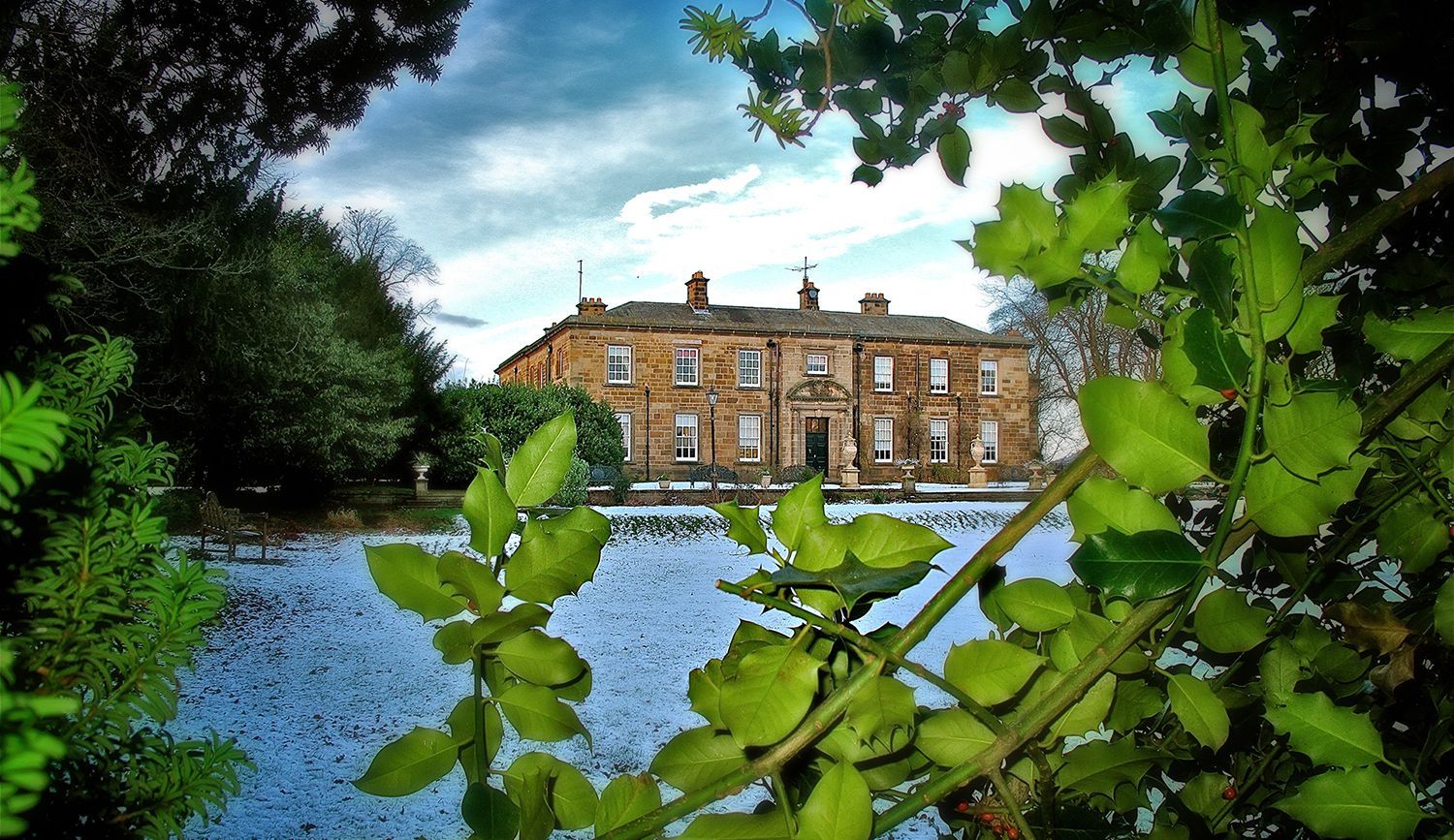 Nunthorpe Hall surrounded by holly and snow in winter