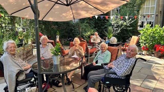 Residents enjoying time together in the garden at Nunthorpe Hall