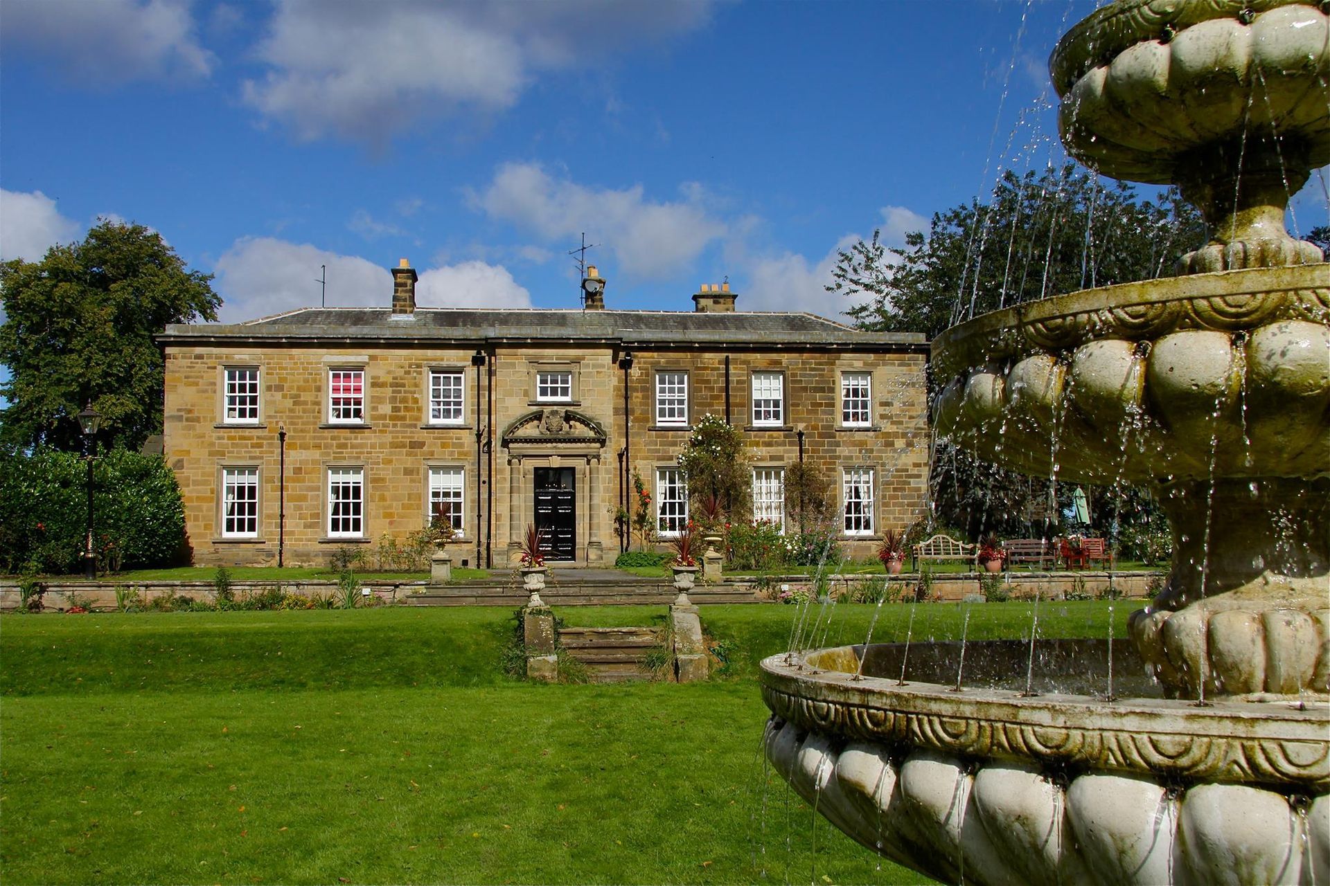 Stone fountain and landscaped gardens at Nunthorpe Hall care home