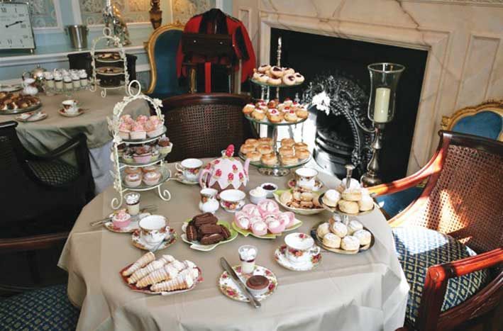 Traditional afternoon tea table with cakes, sandwiches and teaware at Nunthorpe Hall
