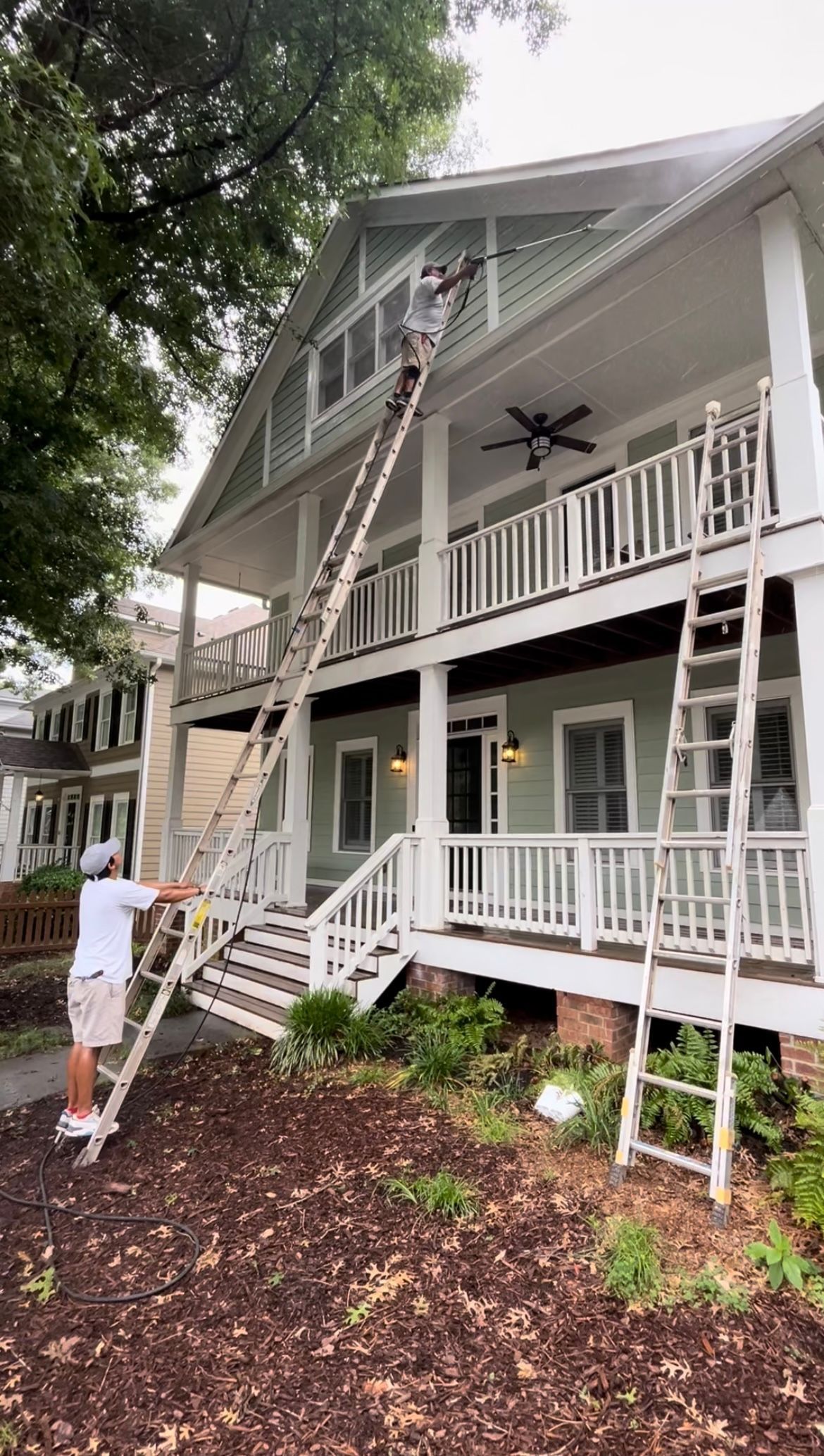  pressure washing a home exterior to prepare for a fresh coat of paint.