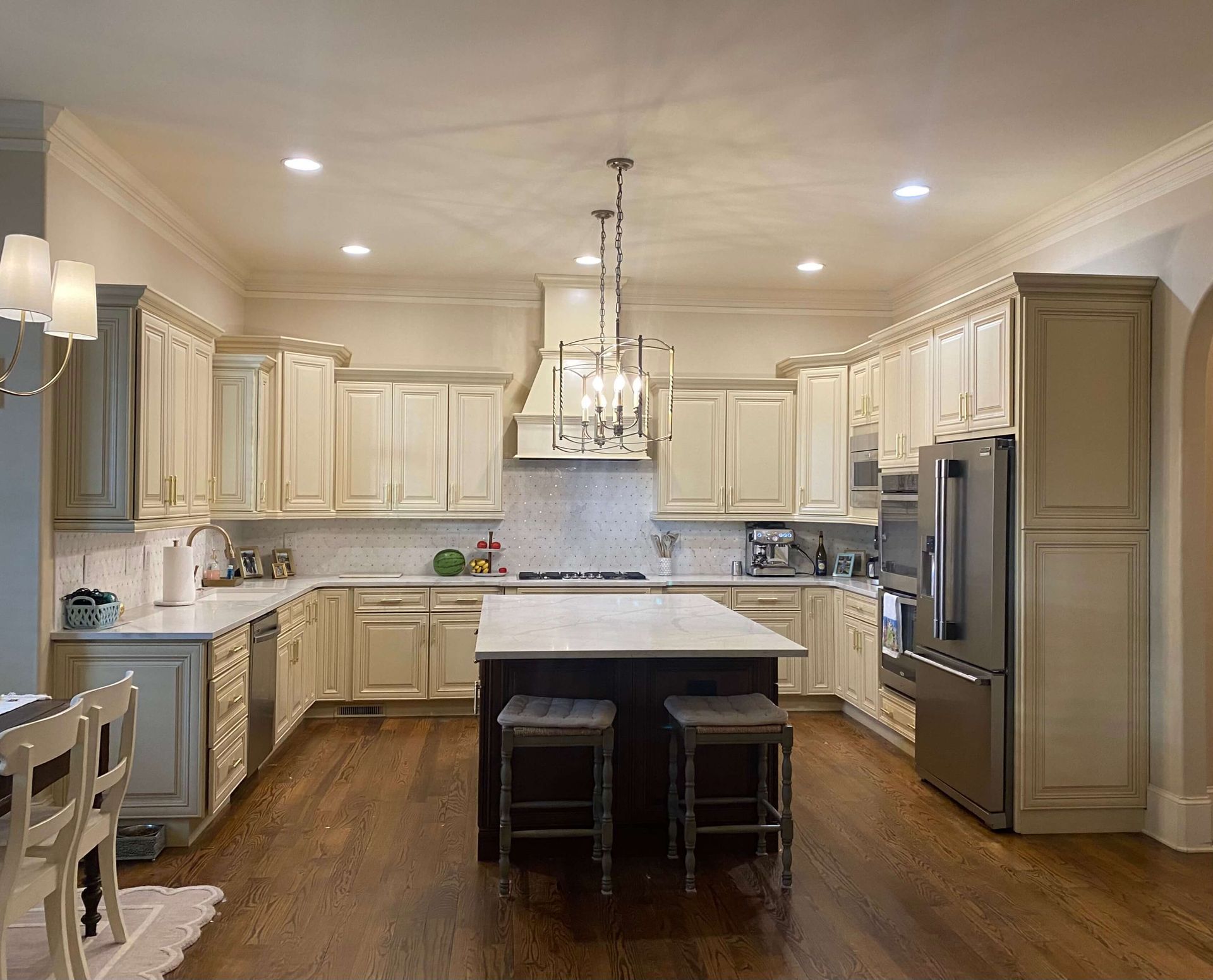 Kitchen cabinets before painting, showing worn surfaces and outdated finish.