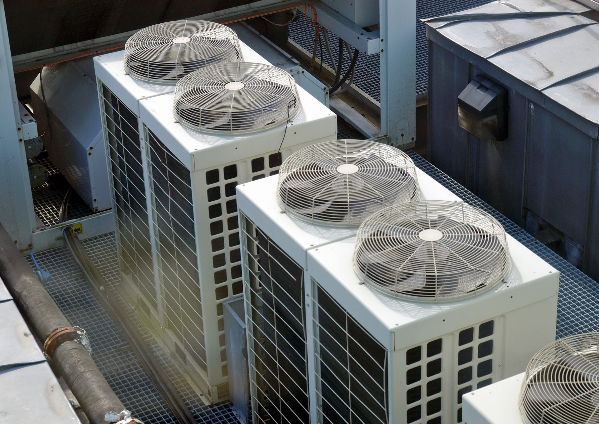 A row of air conditioners on top of a building