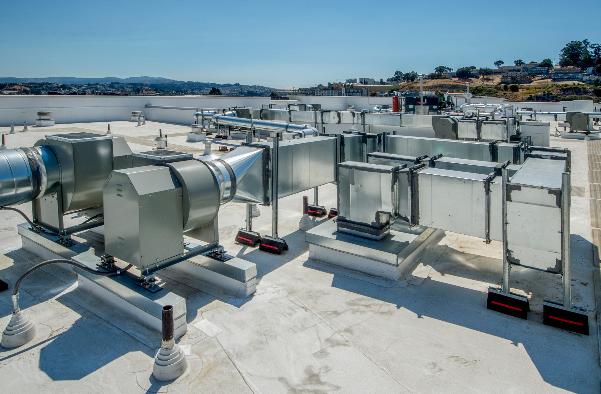 A roof with a lot of pipes and fans on it
