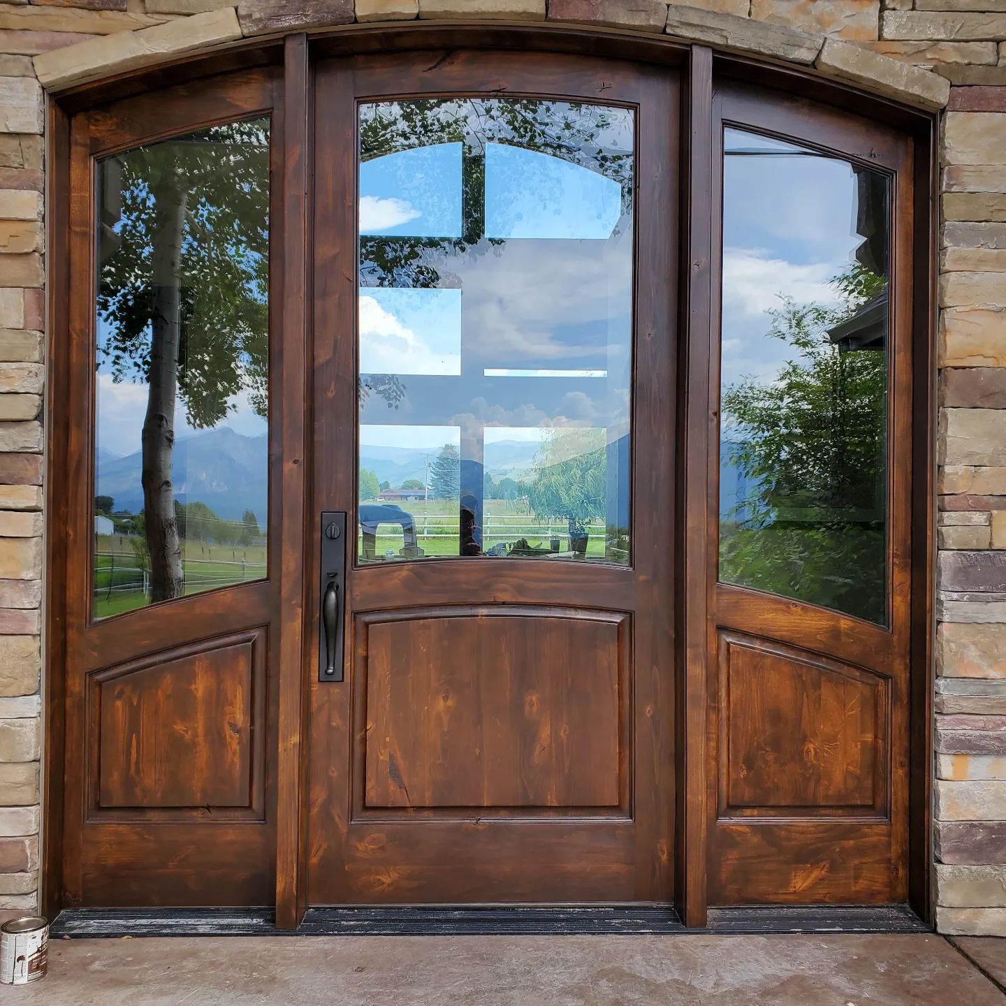 A wooden door with a stone wall behind it