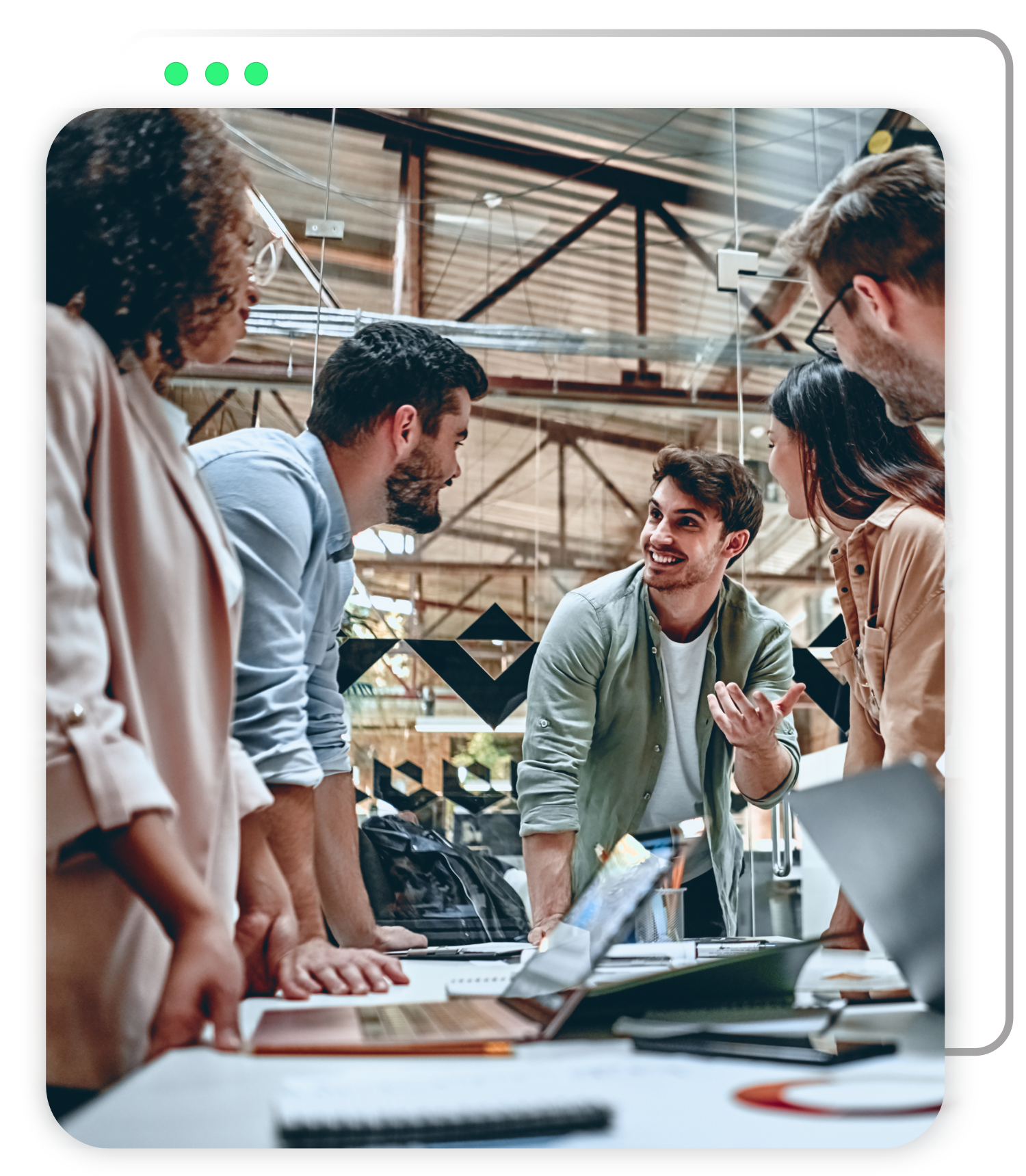 A group of people are standing around a table talking to each other.