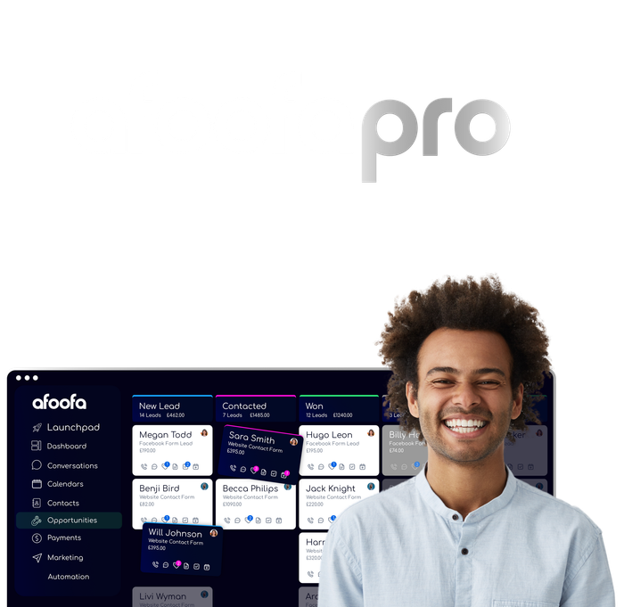 A man is smiling in front of a computer screen.