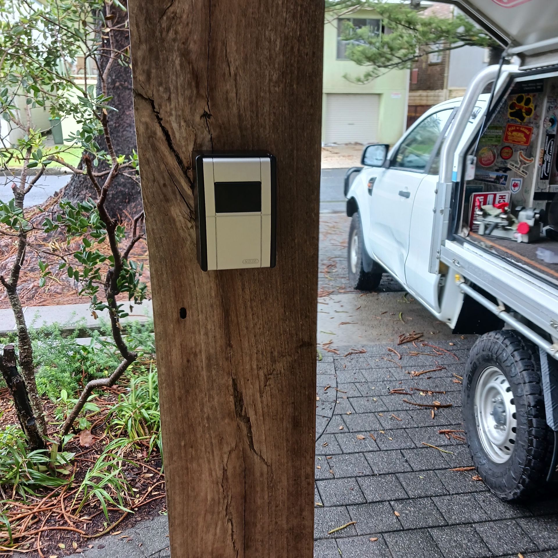 Dark Gray Security Safe With Keypad and Dial in a Wooden Cabinet — Yamba Locksmiths in Yamba, NSW